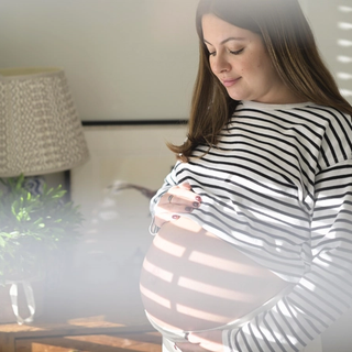 Woman staring adoringly at bump
