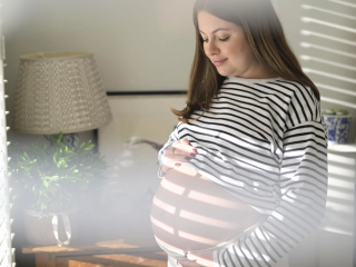 Woman staring adoringly at bump