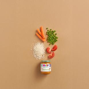 HiPP Organic Vegetables with Rice & Chicken jar with carrots, peas, rice and tomato pieces on a neutral background