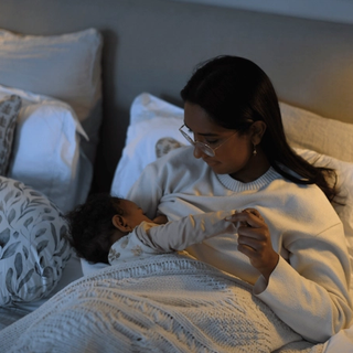 Mum breastfeeding baby in bed