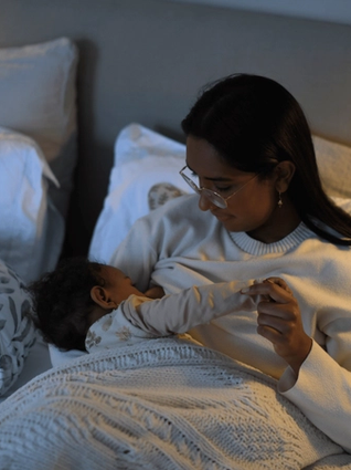 Mum breastfeeding baby in bed