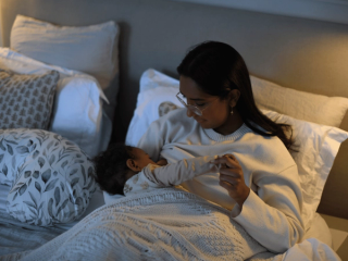 Mum breastfeeding baby in bed