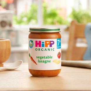 HiPP Organic Vegetable Lasagne on a dining table next to a bowl and spoon