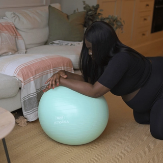 Pregnant mum stretching on exercise ball