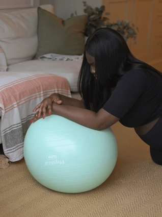 Pregnant mum stretching on exercise ball