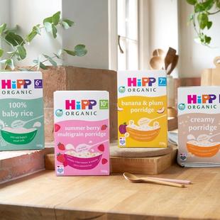HiPP Organic 100% baby rice and porridge boxes arranged on a bright kitchen worktop, ready for baby weaning from 6 months.