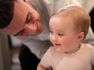 Dad smiling with baby