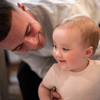 Dad smiling with baby