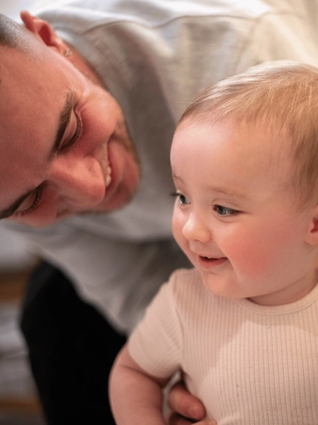 Dad smiling with baby
