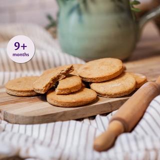Several baby-friendly gingerbread biscuits on a cooling rack