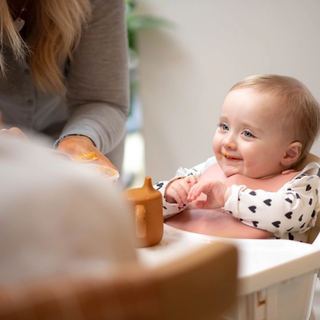 Dad spoon feeding baby