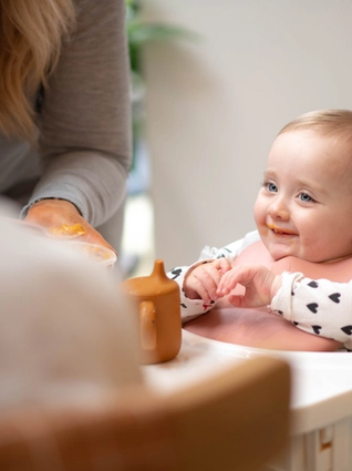 Dad spoon feeding baby