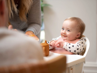 Dad spoon feeding baby