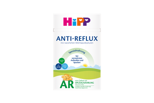 HiPP ANTI-REFLUX Spezialnahrung Packung mit Hinweis „bei vermehrtem Aufstoßen und Spucken“ vor sanfter Landschaftsgrafik.