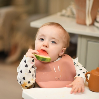 Toddler eating watermelon