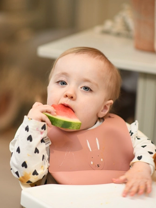 Toddler eating watermelon