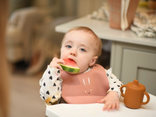 Toddler eating watermelon