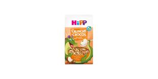 HiPP Crunchy Crocos Apfel-Zimt Bio-Kinder-Müsli mit fröhlichem Krokodil-Maskottchen auf orangefarbener Verpackung