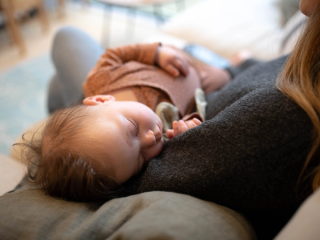 Baby sleeping in mum's arms