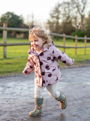 Toddler running down path