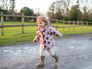 Toddler running down path