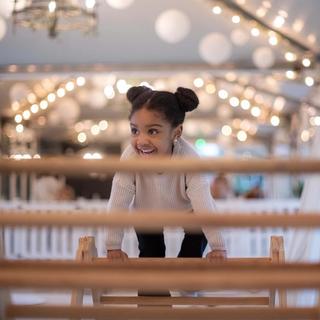 Little girl playing on climbing frame