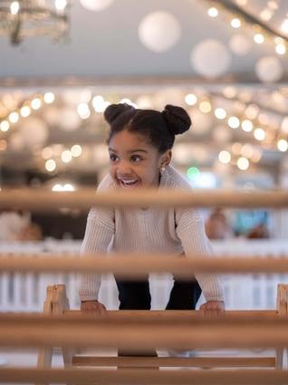 Little girl playing on climbing frame