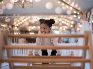 Little girl playing on climbing frame