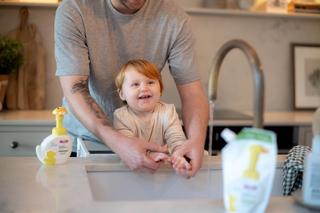 Toddler getting help from dad by a sink using HiPP Kids Handwash Duck