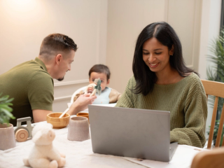 Mum working for home whilst dad feeds baby