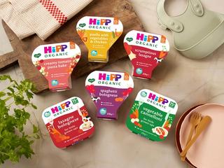 Selection of HiPP Organic toddler meal trays with a bib, plate and cutlery