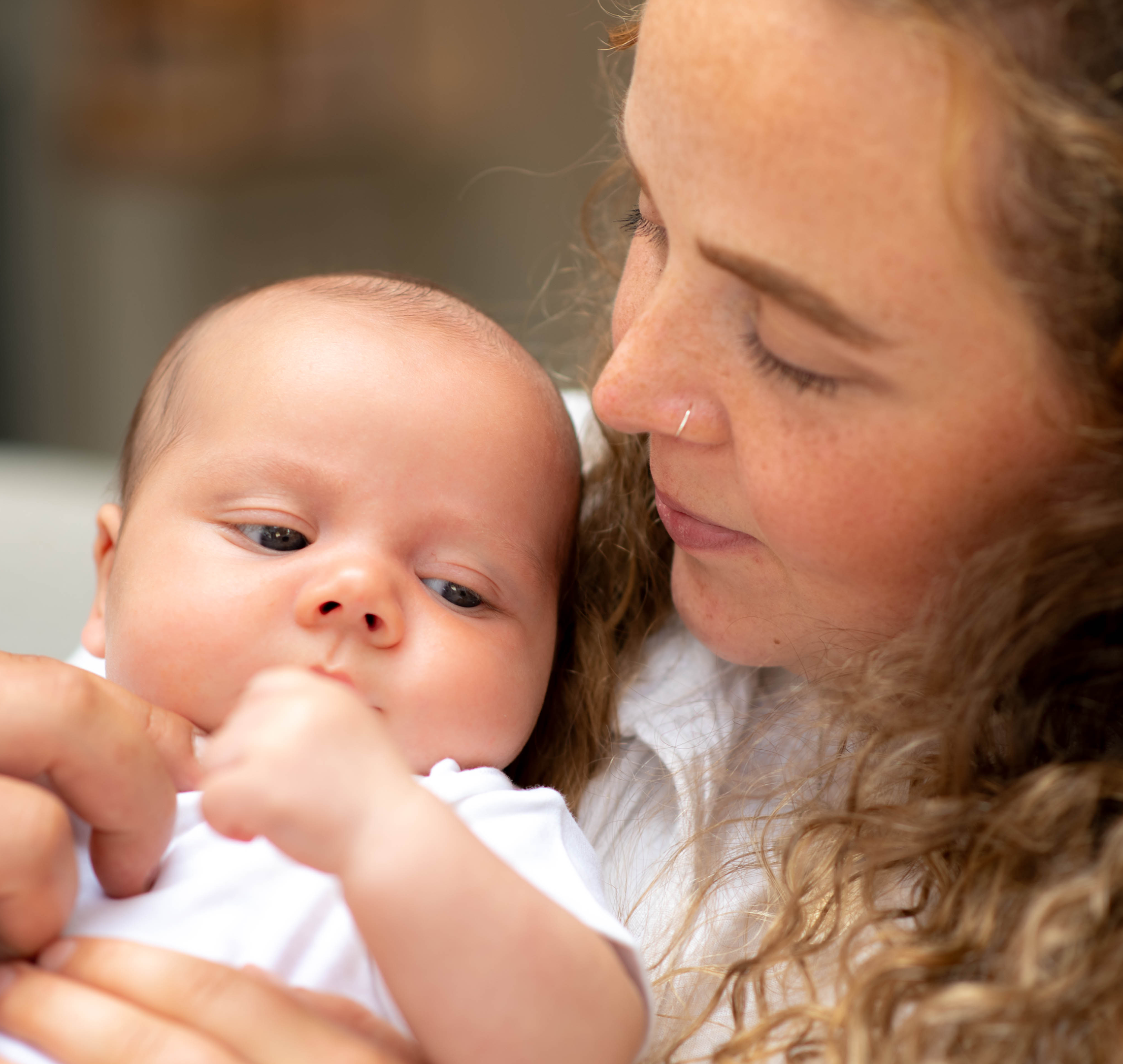 A close-up shot of mum and baby looking at each other