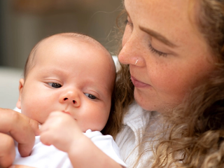 A close-up shot of mum and baby looking at each other