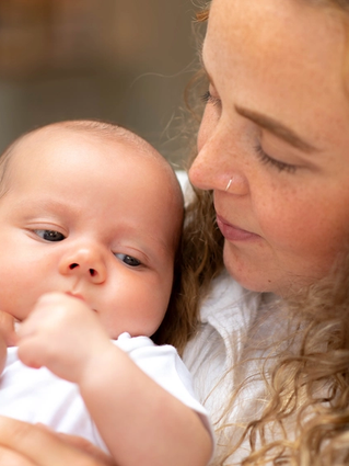 A close-up shot of mum and baby looking at each other