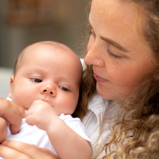 A close-up shot of mum and baby looking at each other