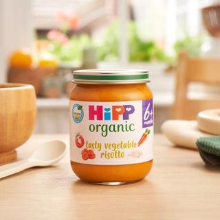 HiPP Organic Tasty Vegetable Risotto on a dining table next to a bowl and spoon