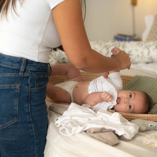 Mum changing baby's nappy