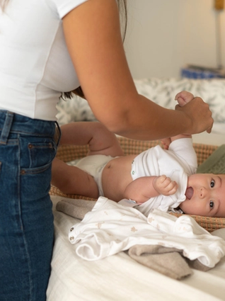 Mum changing baby's nappy
