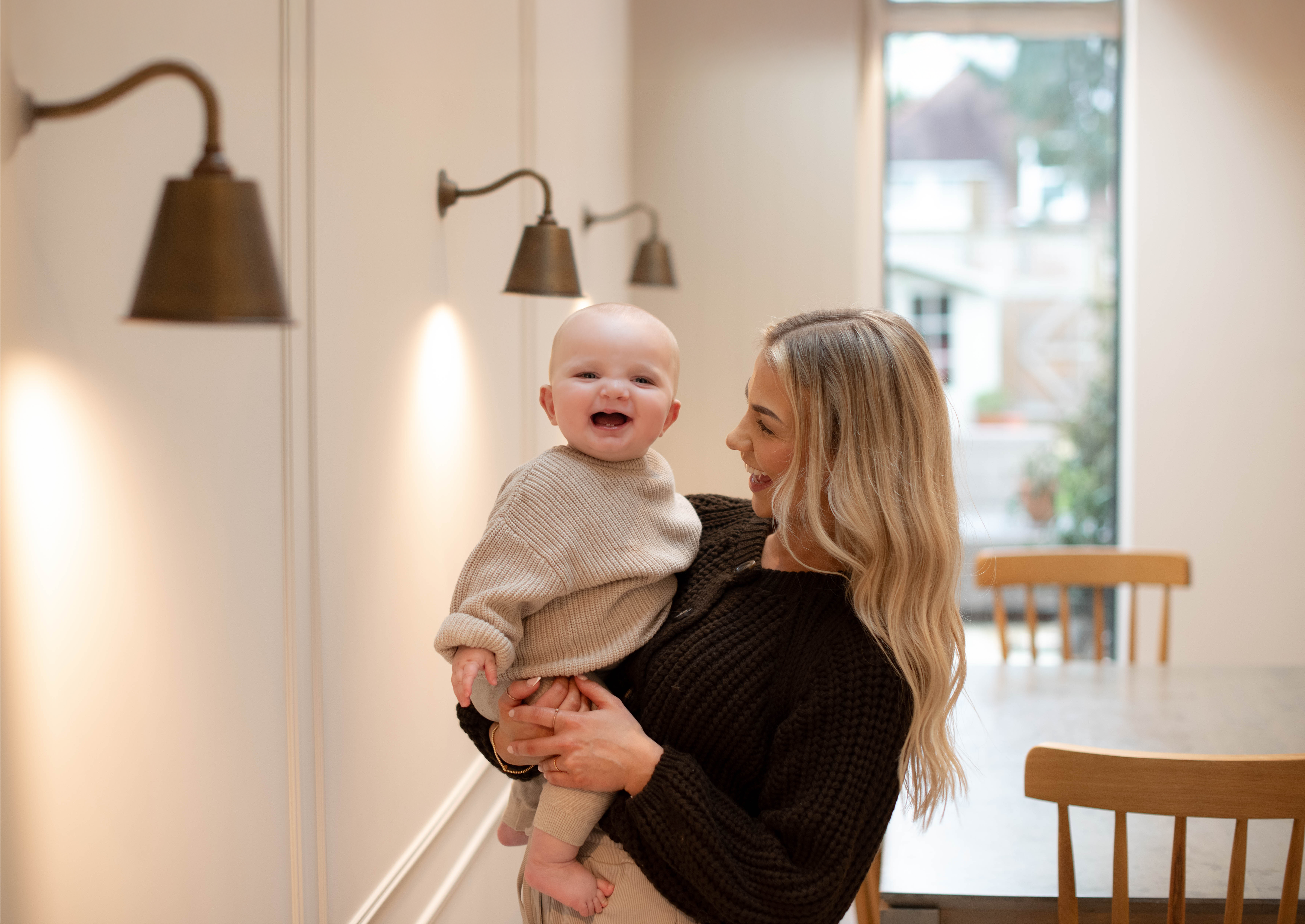 Mum holding baby both smiling