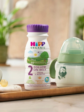 HiPP Organic Follow On Milk next to a baby bottle