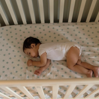 Baby sleeping in cot