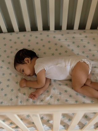 Baby sleeping in cot