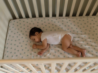 Baby sleeping in cot