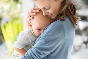Mutter hält ihr Baby eng an der Brust und tröstet es liebevoll während der Stillzeit und des Milcheinschusses