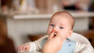 Baby being fed by a spoon