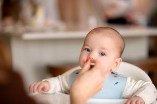 Baby being fed by a spoon