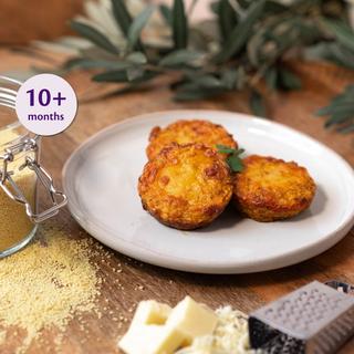Three baked Bolognese cous cous bites on a white plate, shown as a finger food recipe suitable for babies 10+ months.