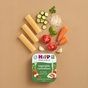 HiPP Organic Vegetable Cannelloni tray with pasta tubes and fresh vegetables arranged on a neutral background