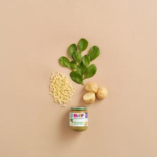 HiPP Organic Cheesy Potato & Spinach Bake jar with spinach leaves, potatoes and grated cheese on a neutral background