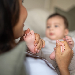 Mum rubbing baby's feet